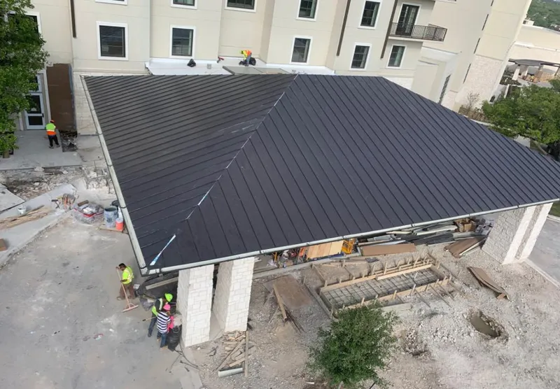 Metal roofing installation team working on a commercial building in Opelika